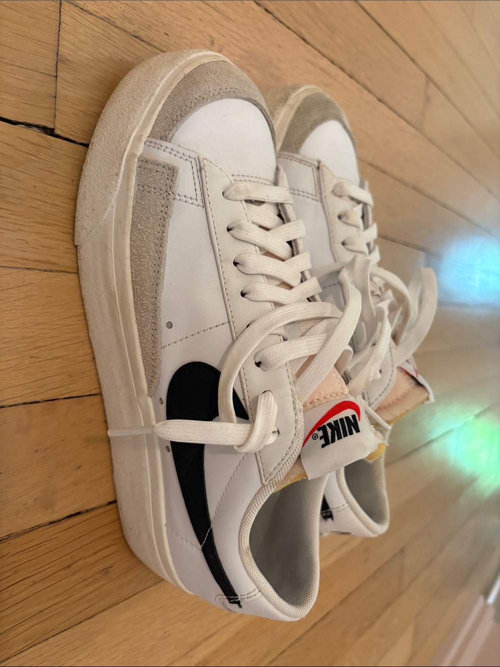 Nike White Low-Top Sneakers with Black Swoosh and Beige Suede